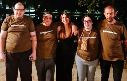 Fotografia noturna com cinco pessoas alinhadas. Quatro dessas pessoas usam camisola castanha igual com a expressão (In)Segurança em letras brancas.